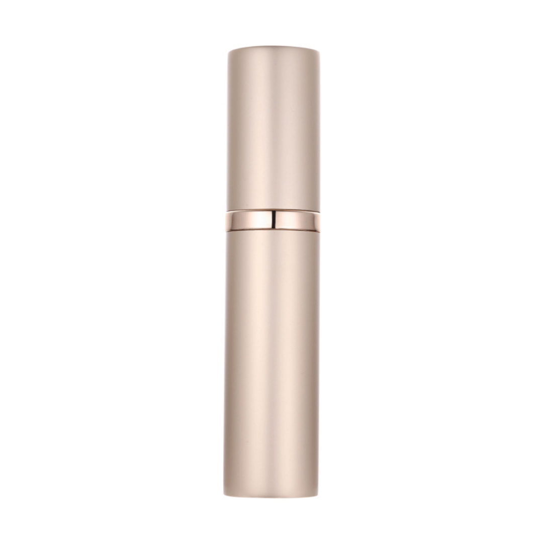 A hand holding a black travel-size perfume atomizer with a fine spray of perfume, highlighting the product's capability to spray without water drops.