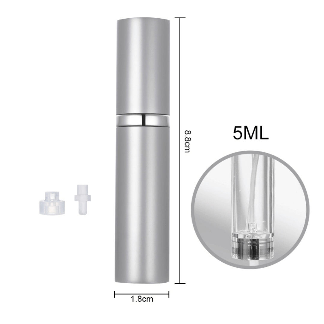 A hand holding a black travel-size perfume atomizer with a fine spray of perfume, highlighting the product's capability to spray without water drops.