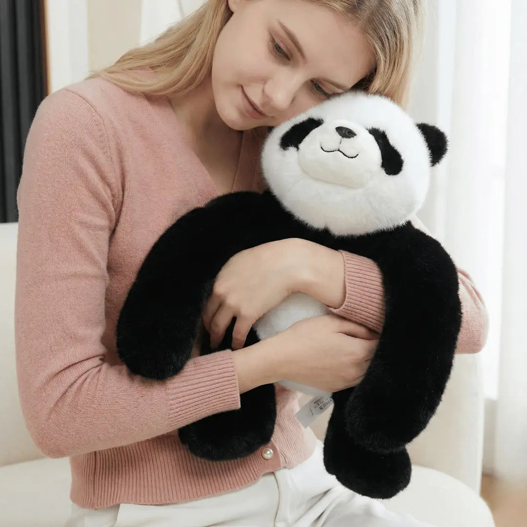 Woman holding a plush panda toy in a cozy indoor setting