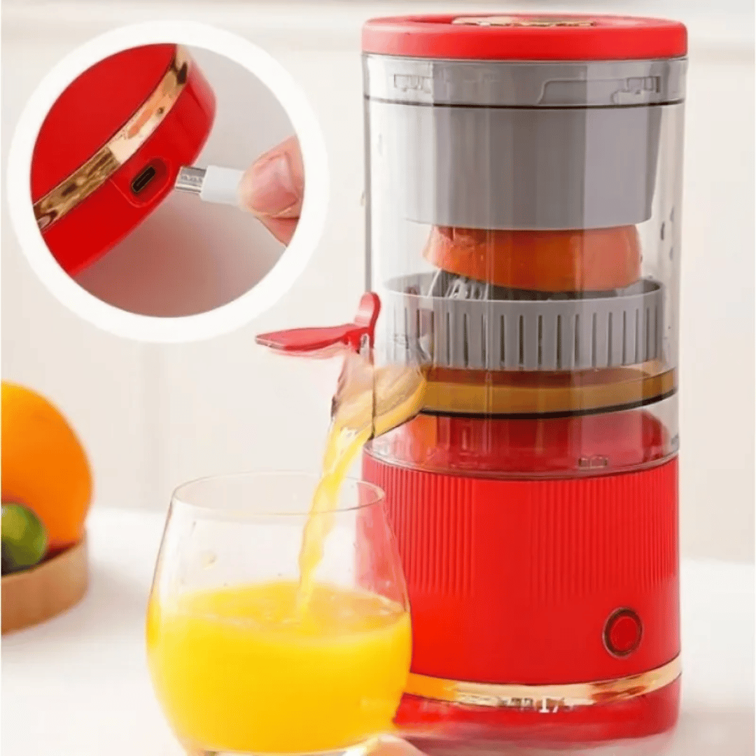 Red manual juicer with a glass of orange juice on a white background