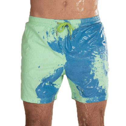 A collection of SplashShift Shorts in various colors, featuring a man modeling the yellow pair, with other pairs shown in blue, orange, and green splattered patterns.