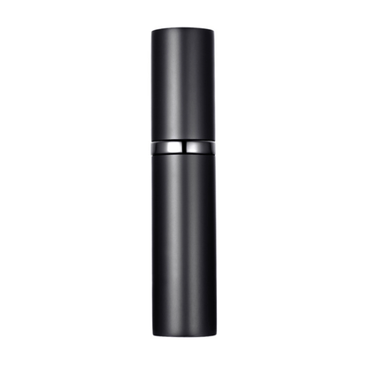 A hand holding a black travel-size perfume atomizer with a fine spray of perfume, highlighting the product's capability to spray without water drops.