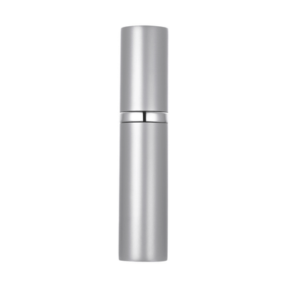 A hand holding a black travel-size perfume atomizer with a fine spray of perfume, highlighting the product's capability to spray without water drops.