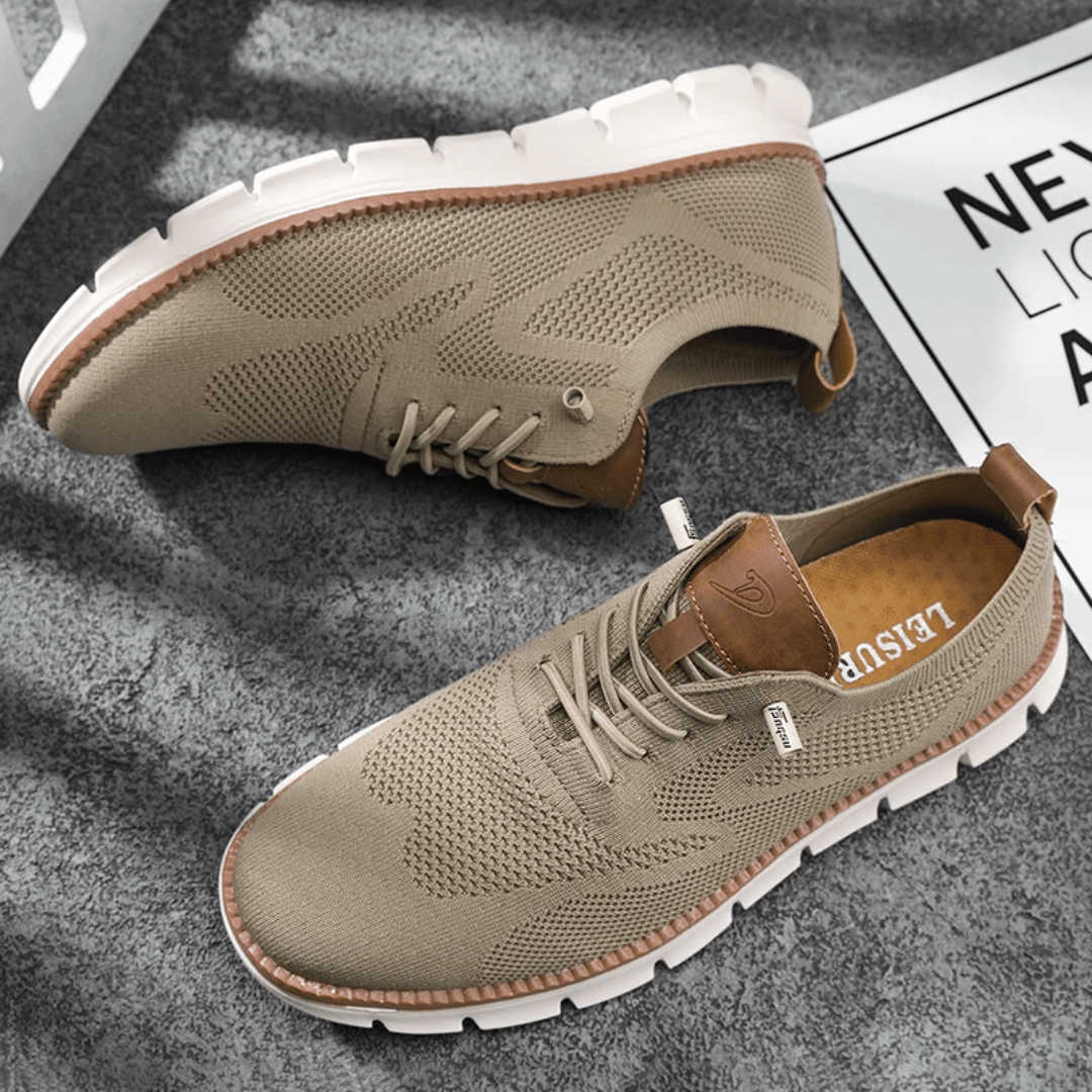 A pair of beige Hugo Ultra Comforatable Shoes on a textured surface, showcasing the side profile of the sneakers with lace-up closure.