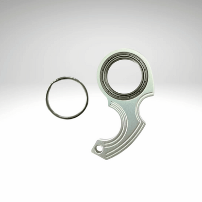 A keychain fidget spinner accessory disassembled into two pieces, a black main component and a metallic ring, displayed against a white background.