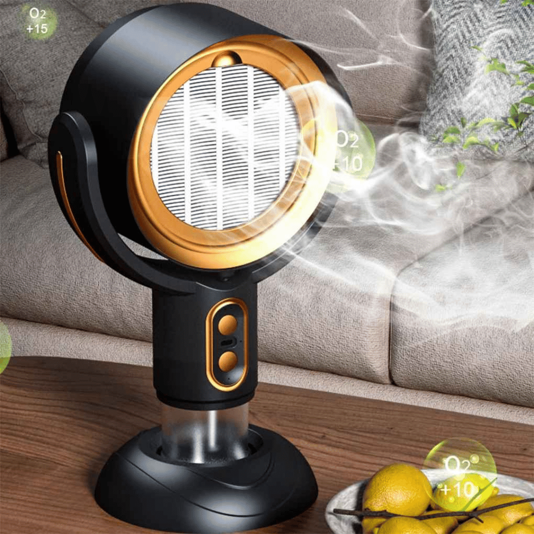 A compact and modern air purifier, the AirSphere Pro, with a black and orange color scheme, positioned on a wooden table beside citrus fruits, indicating its function of air purification.