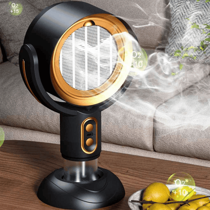 A compact and modern air purifier, the AirSphere Pro, with a black and orange color scheme, positioned on a wooden table beside citrus fruits, indicating its function of air purification.