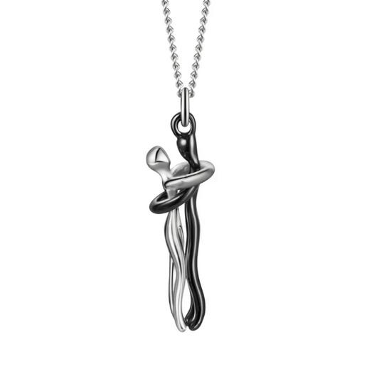 A sleek and artistic silver necklace with a pendant in a hugging design, symbolizing love and connection.