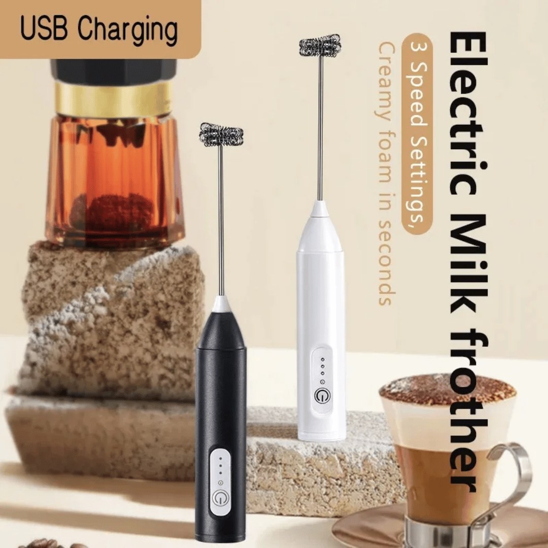 Two electric milk frothers, one black and one white, displayed next to a cup of coffee and a container of milk, with USB charging cable in the background.
