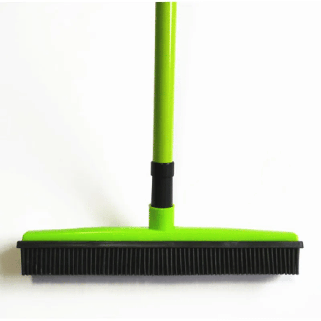 Green broom with black bristles on a white background