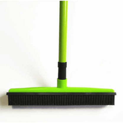 Green broom with black bristles on a white background