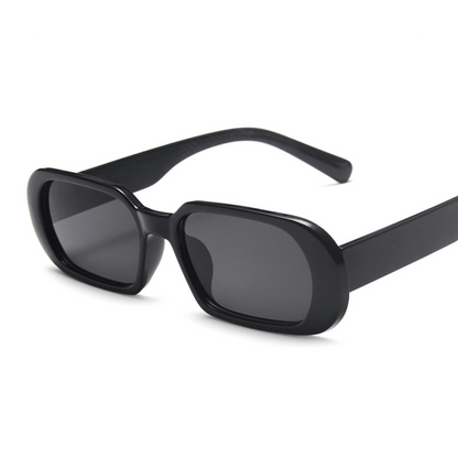 A pair of NoirVision black sunglasses with a minimalist design, displayed against a white background.