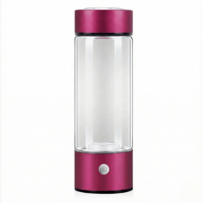 Clear glass bottle with a pink metallic top and base on a white background