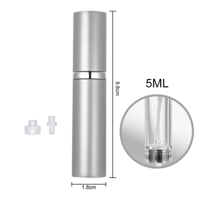 A hand holding a black travel-size perfume atomizer with a fine spray of perfume, highlighting the product's capability to spray without water drops.