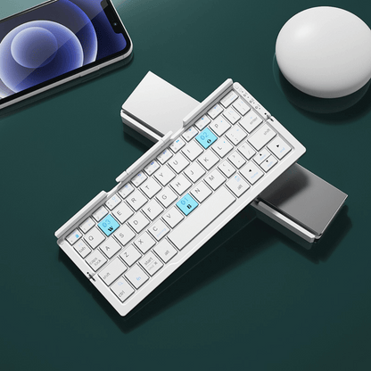 Foldable keyboard with smartphone and mouse on a dark surface
