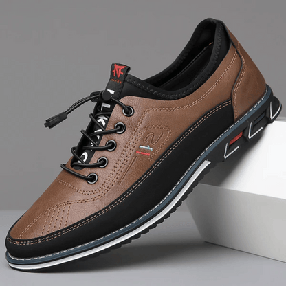 A pair of Oxford Comfort Sneakers featuring a brown upper with black accents and a white sole.