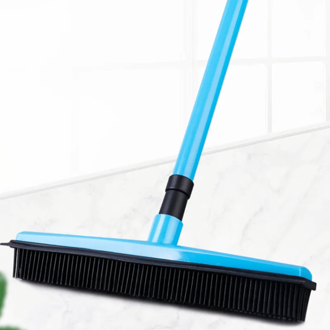 Blue broom with black bristles on a white tiled floor