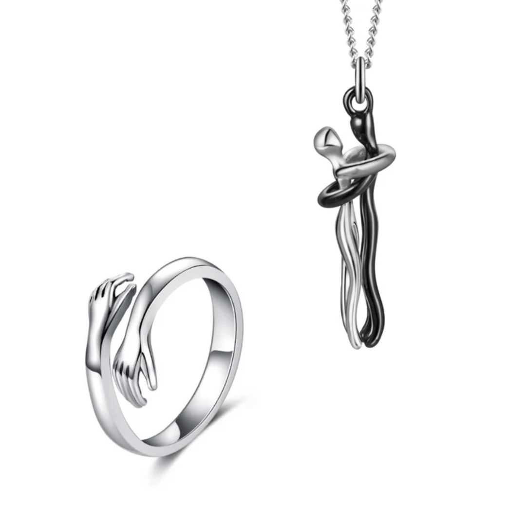 A sleek and artistic silver necklace with a pendant in a hugging design, symbolizing love and connection.