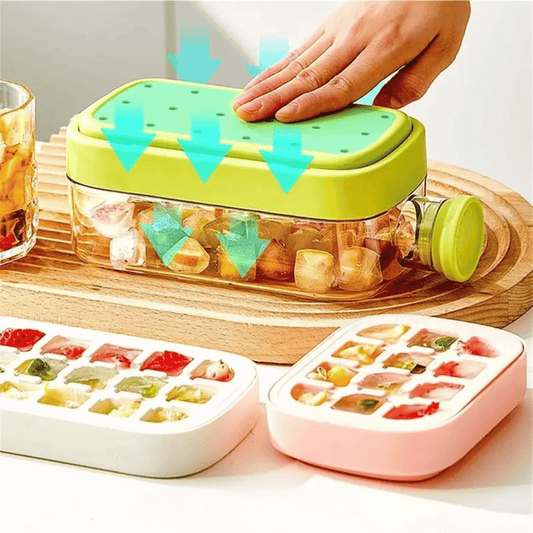 Green ice cube tray with colorful ice cubes on a wooden surface, next to a pink ice cube tray.