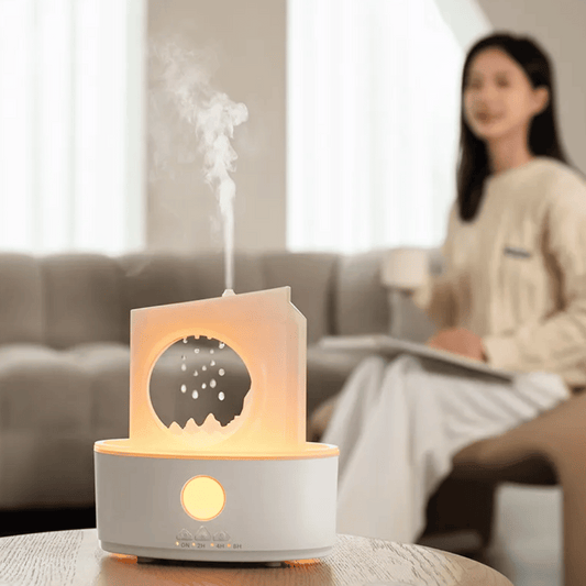 Aroma diffuser emitting steam with a blurred person sitting on a couch in the background