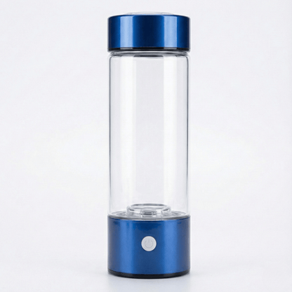 Clear glass bottle with blue metal cap and base on a white background