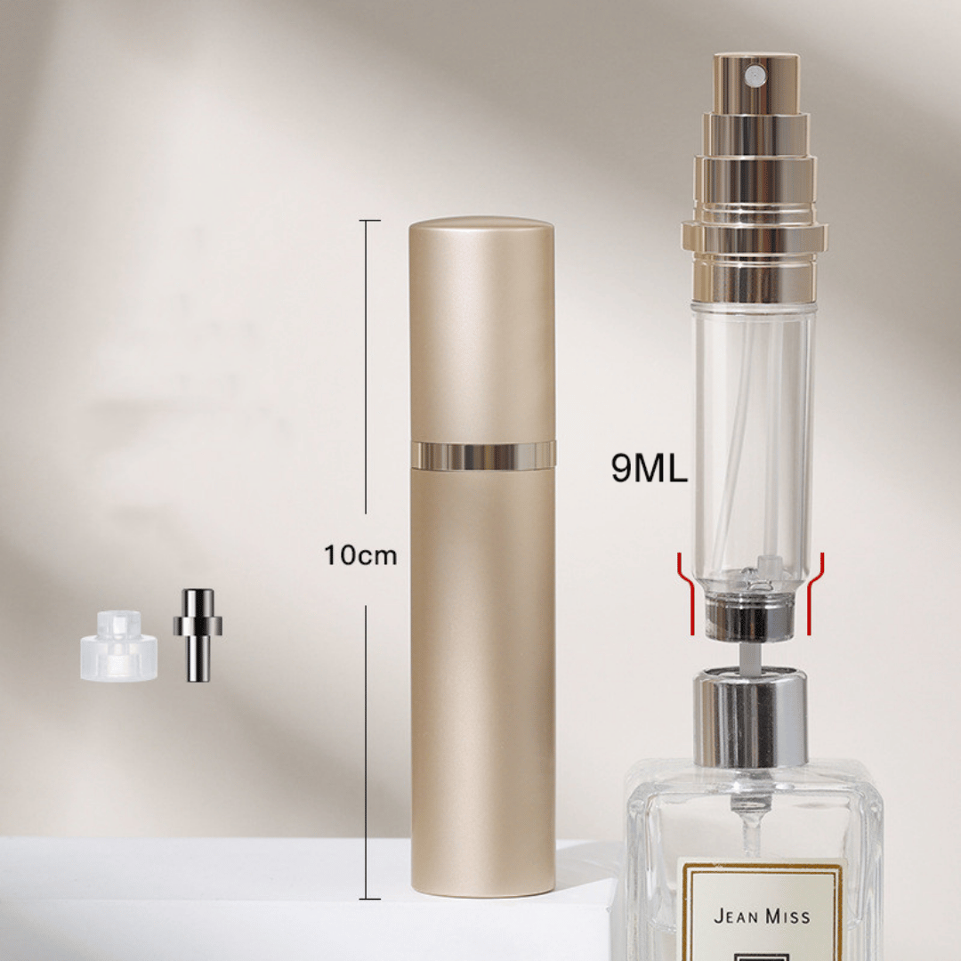 A hand holding a black travel-size perfume atomizer with a fine spray of perfume, highlighting the product's capability to spray without water drops.
