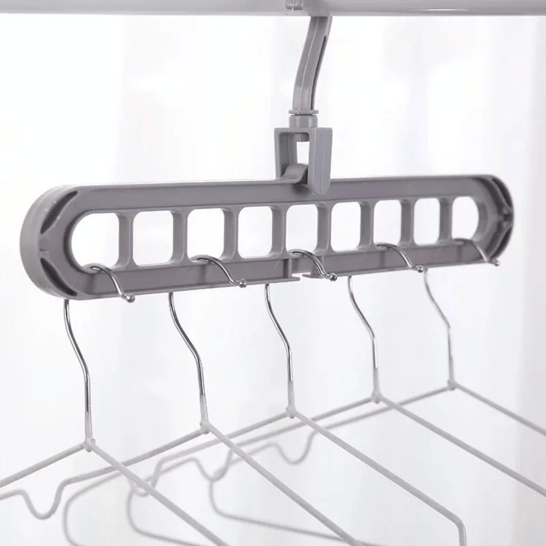 A set of multi-functional space-saving hangers arranged in a wardrobe, holding various garments.