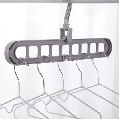 A set of multi-functional space-saving hangers arranged in a wardrobe, holding various garments.
