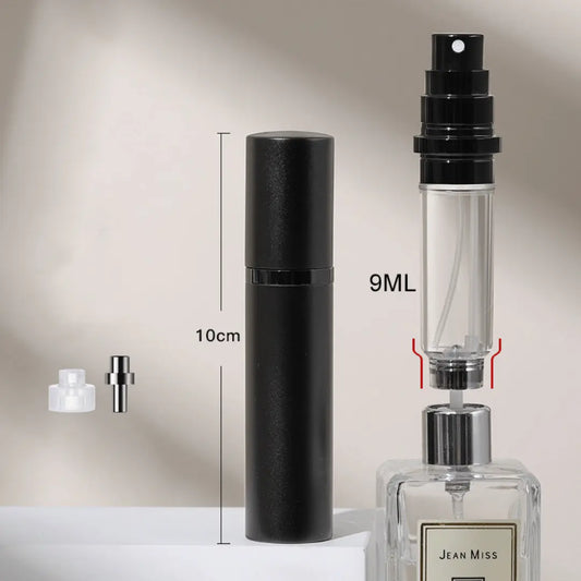 A hand holding a black travel-size perfume atomizer with a fine spray of perfume, highlighting the product's capability to spray without water drops.