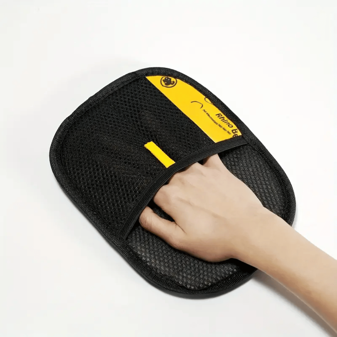 Black and yellow massage pad with a hand on a white background