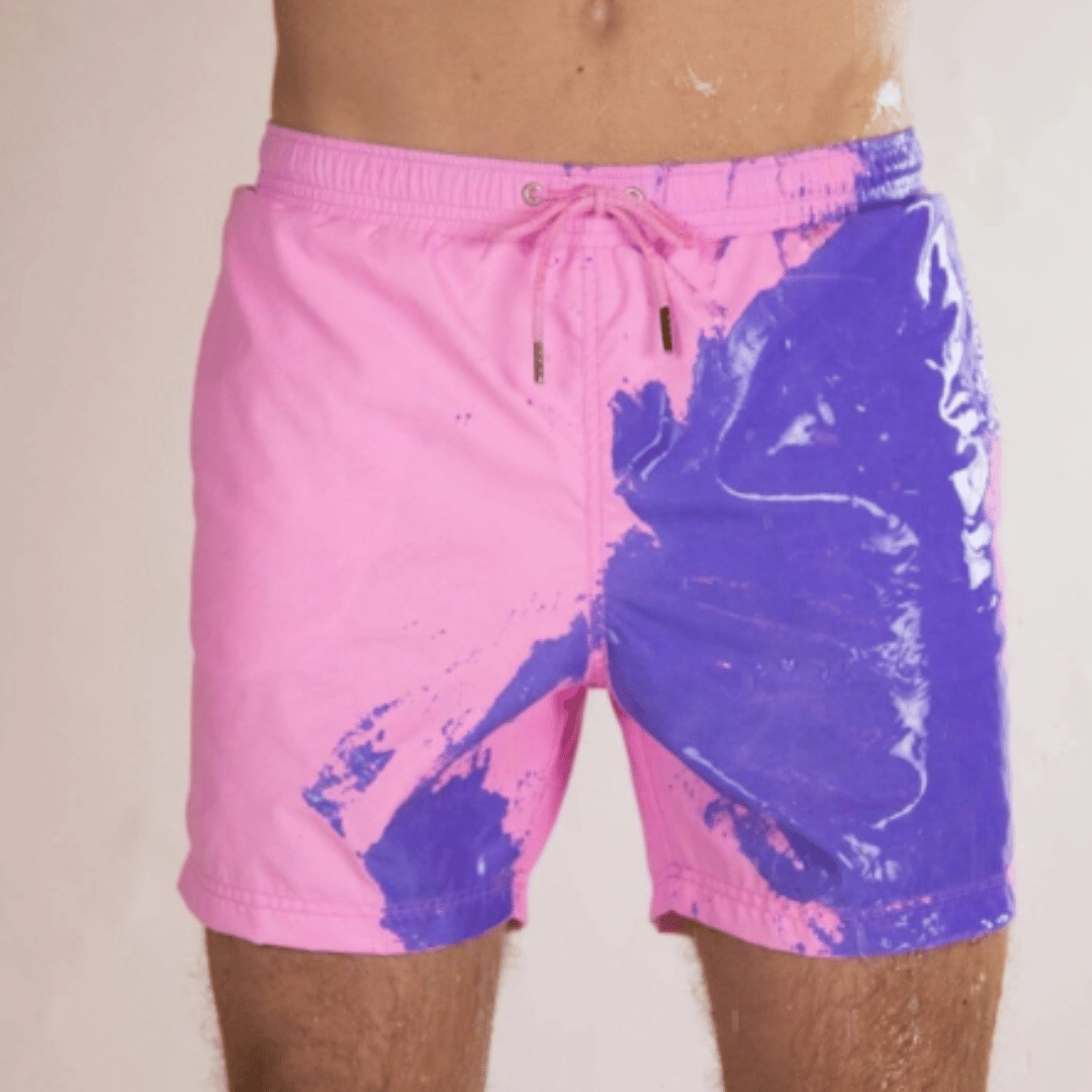 A collection of SplashShift Shorts in various colors, featuring a man modeling the yellow pair, with other pairs shown in blue, orange, and green splattered patterns.