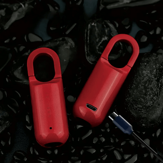 Two red electronic devices with a USB cable on a dark textured background