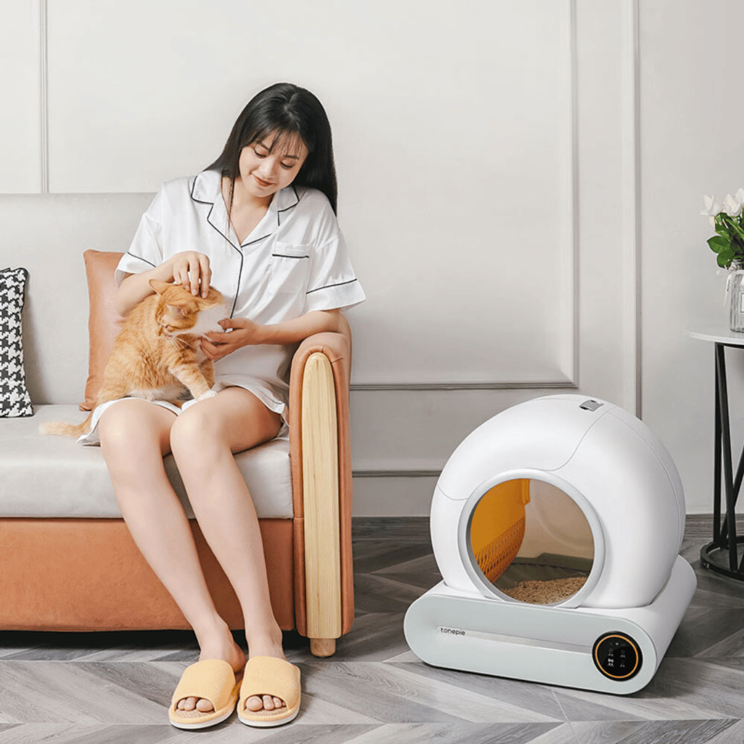 IntelliPurr litter box internal mechanism showing automatic cleaning system and waste collection tray