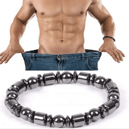 A metabolism booster bracelet, featuring black hematite stones, is displayed in front of a shirtless man wearing blue jeans, highlighting the bracelet's sleek and unisex design.