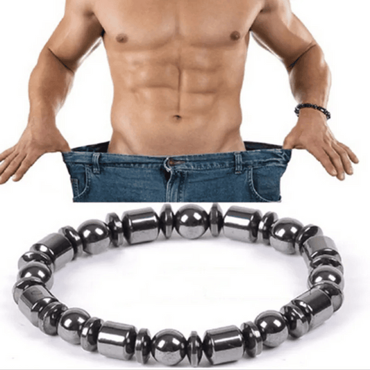 A metabolism booster bracelet, featuring black hematite stones, is displayed in front of a shirtless man wearing blue jeans, highlighting the bracelet's sleek and unisex design.