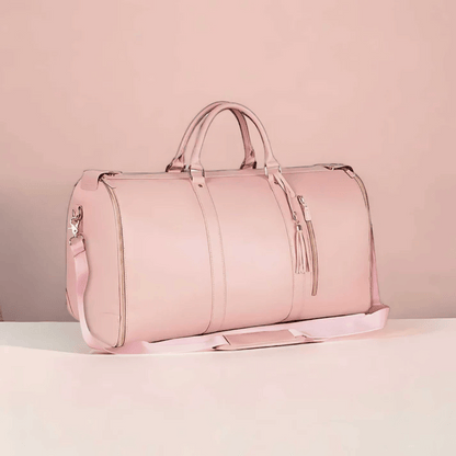 A white and brown Elegance Travel Duffel bag placed against a pink background.