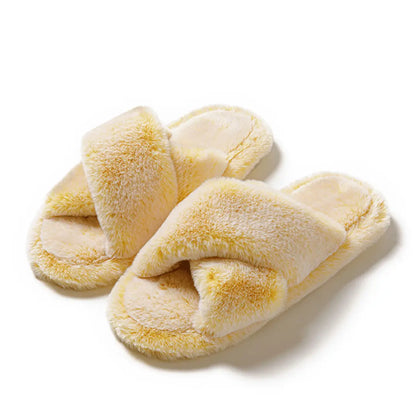 Pair of yellow slippers on a white background