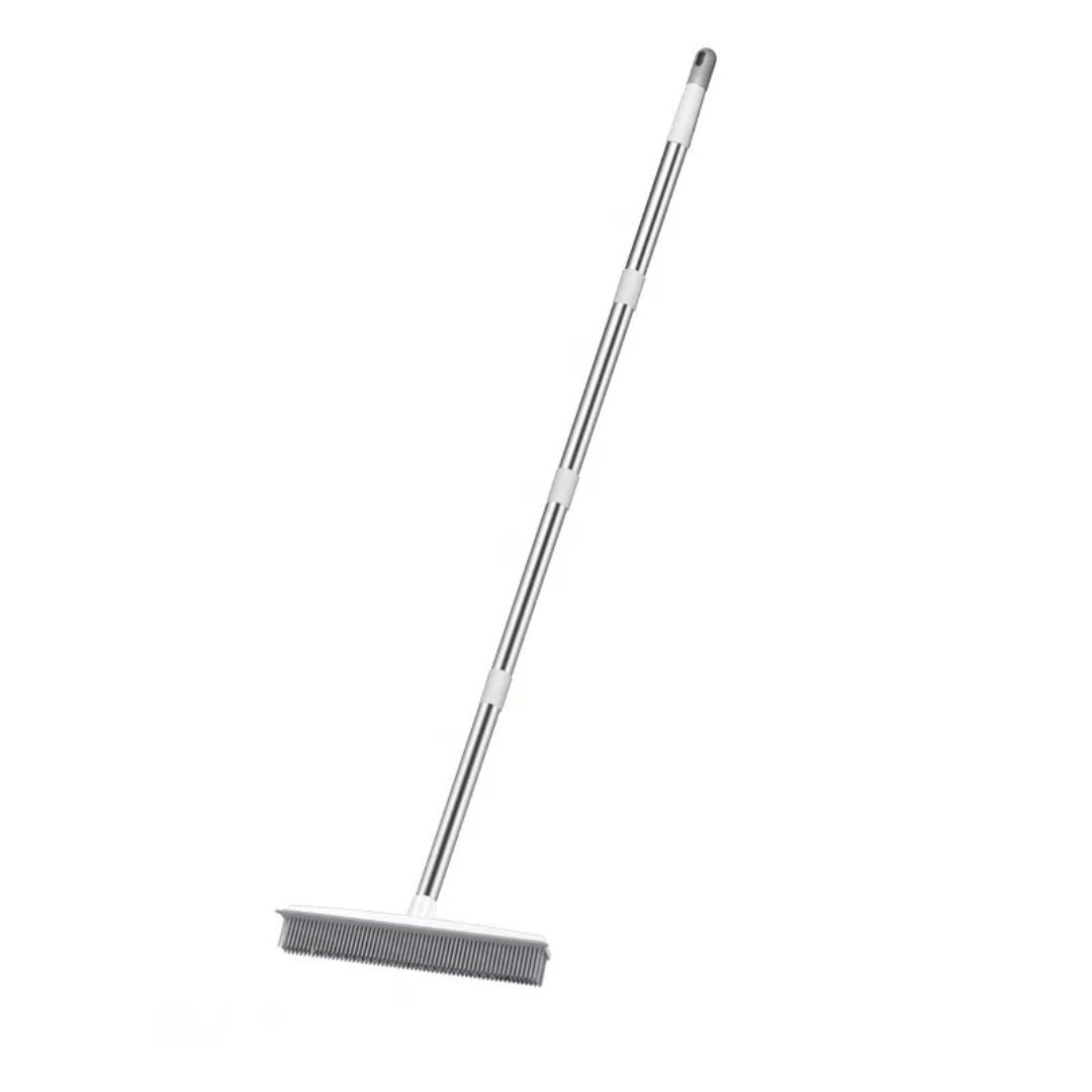 Metal broom with a long handle on a white background
