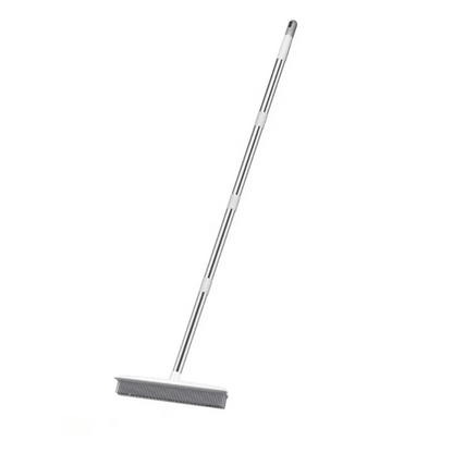 Metal broom with a long handle on a white background