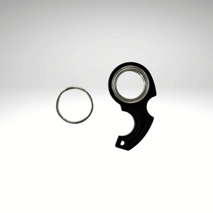 A keychain fidget spinner accessory disassembled into two pieces, a black main component and a metallic ring, displayed against a white background.