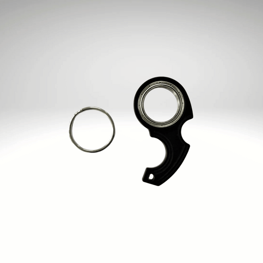 A keychain fidget spinner accessory disassembled into two pieces, a black main component and a metallic ring, displayed against a white background.