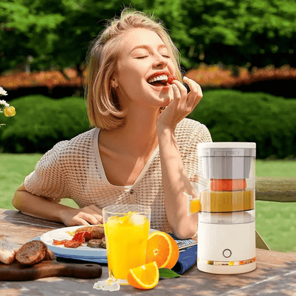 Woman eating outdoors with a blender and fruit on a table
