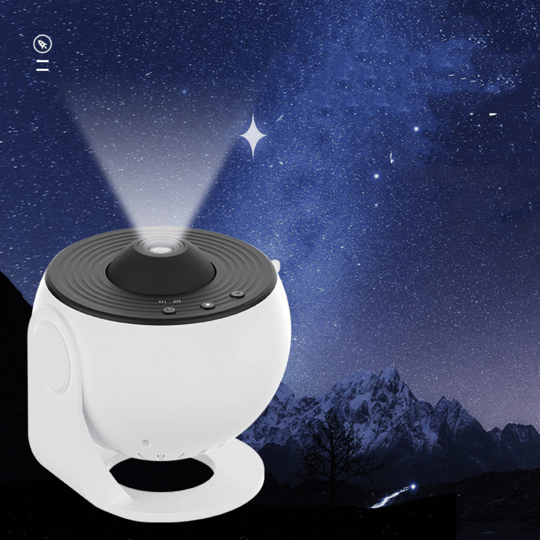 White and black device projecting stars onto a starry night sky with mountains in the background