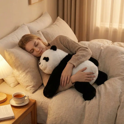 Person lying on a bed with a large panda-shaped pillow