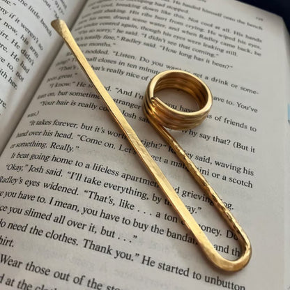 Gold ring and barrette on an open book